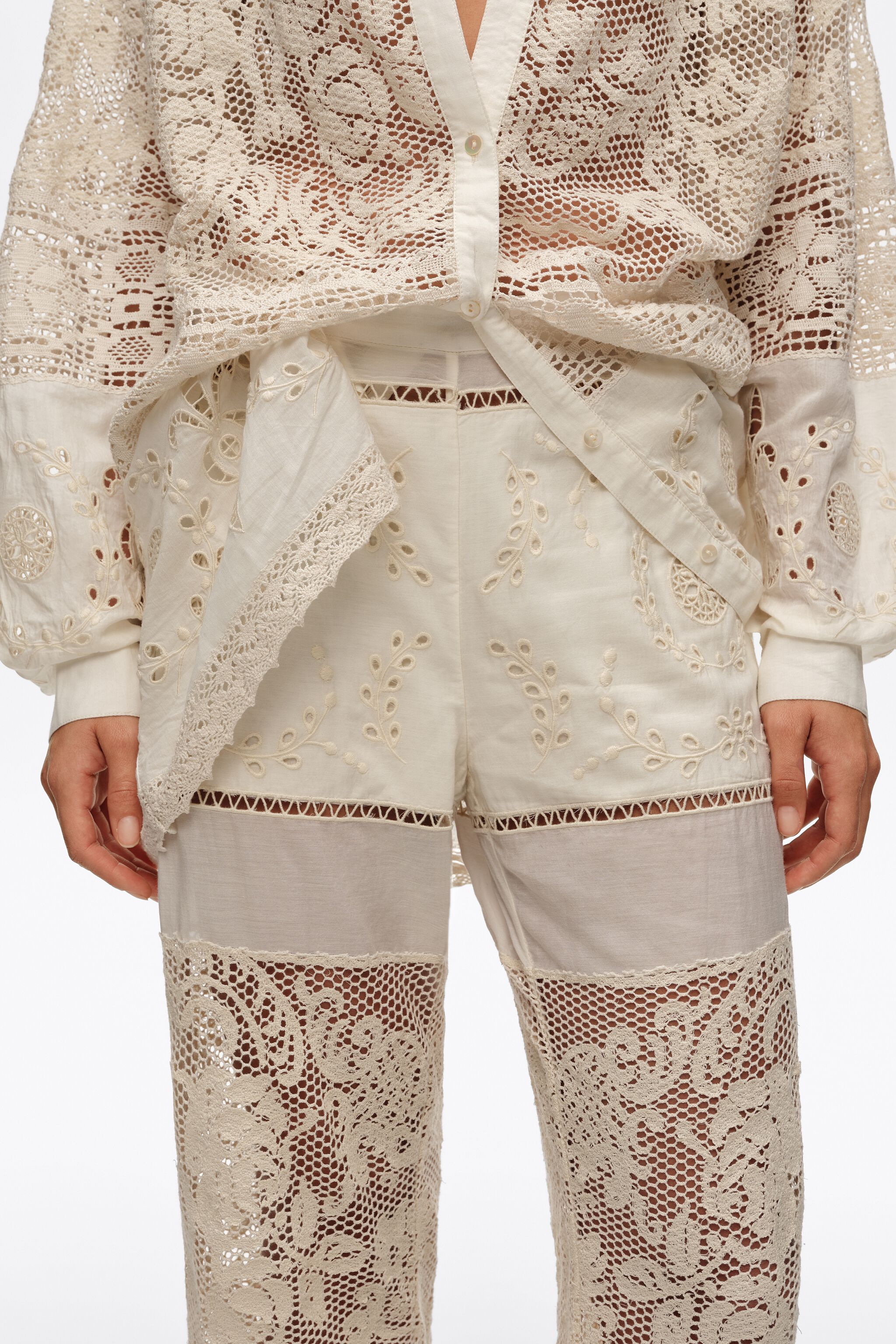 Ecru trousers with embroidery and openwork