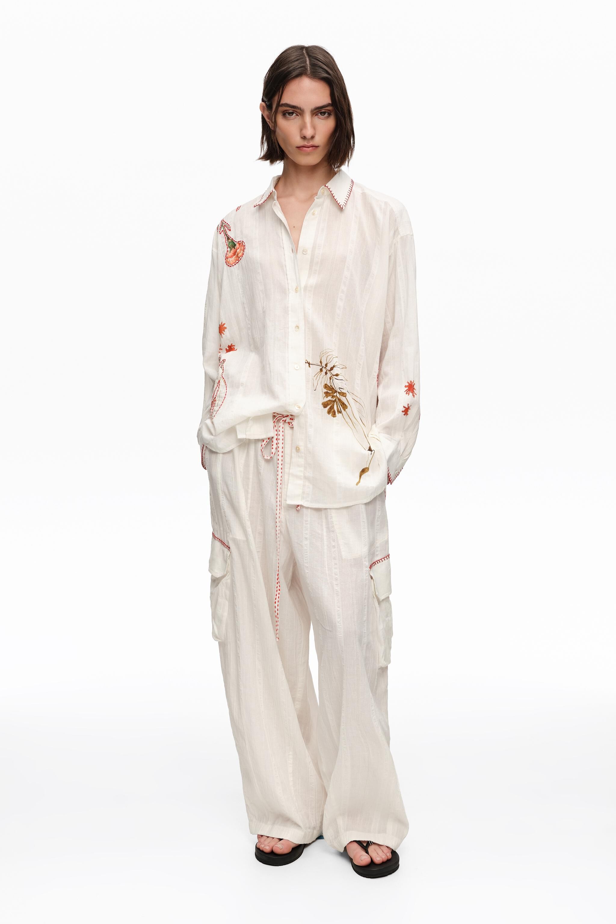 Ivory cargo pants with decorative stitching