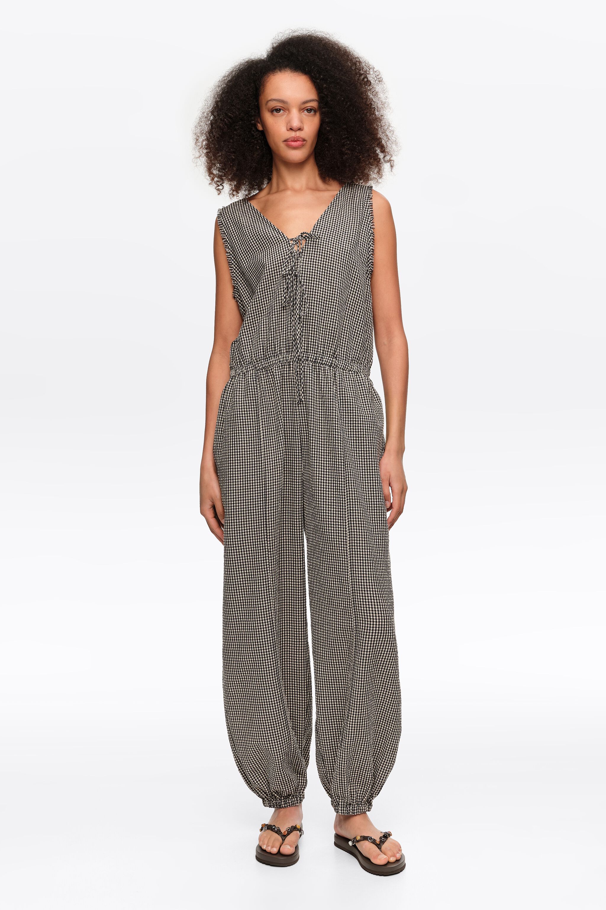 Black checked baggy jumpsuit with bows and frayed details