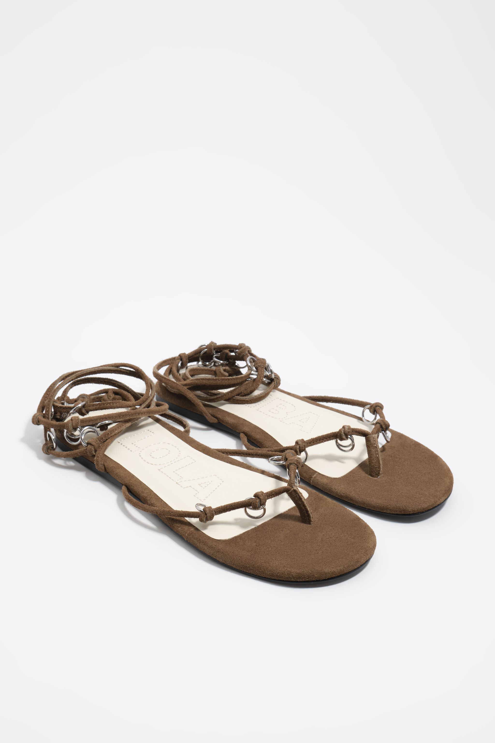 Olive suede sandal with piercings