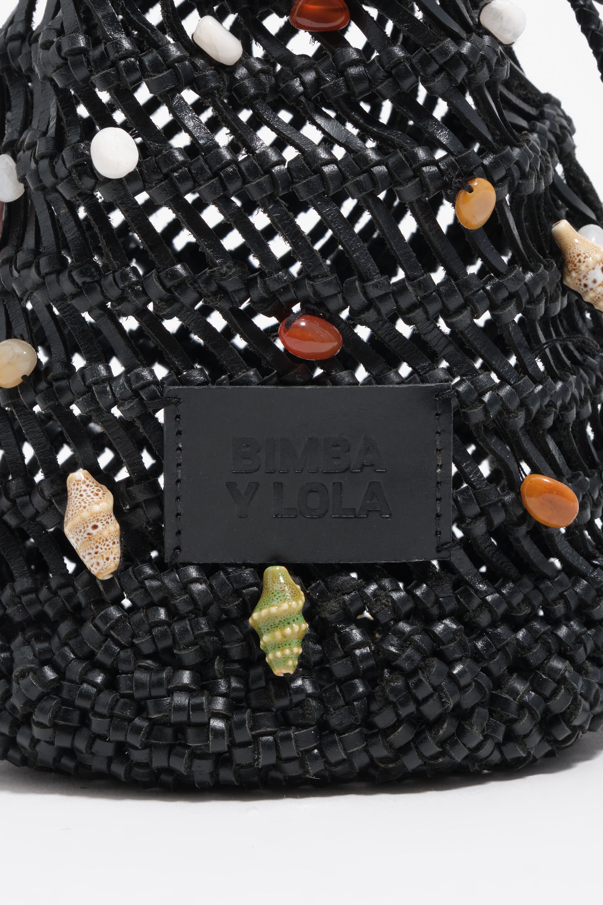 Black mini bucket bag in plaited leather with natural stones