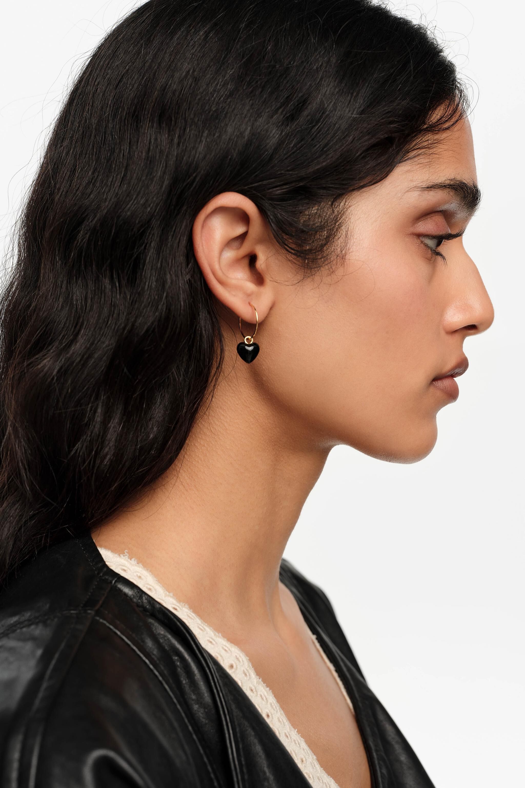Gold hoop earrings and black heart