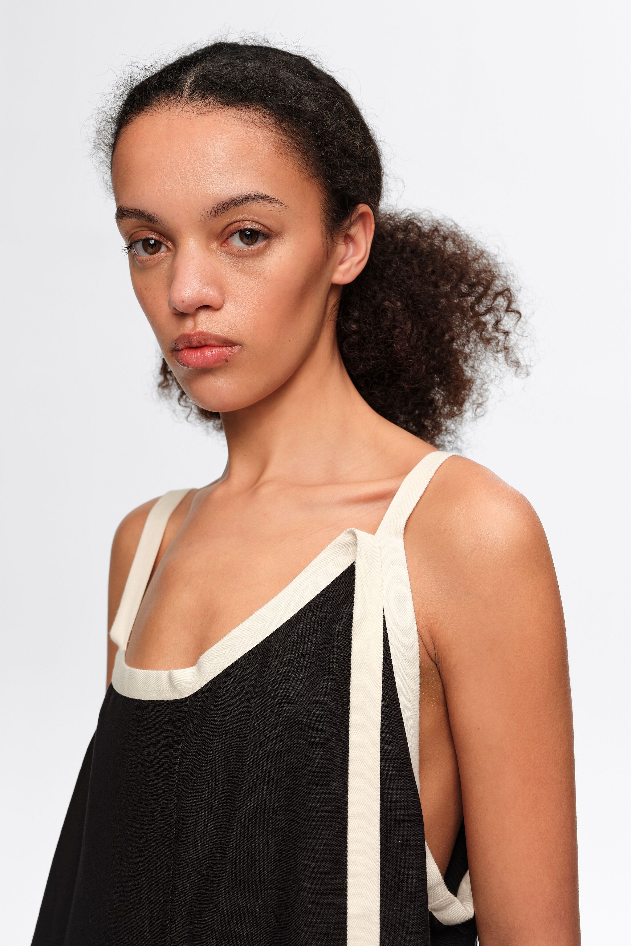 Straight black jumpsuit with contrasting straps