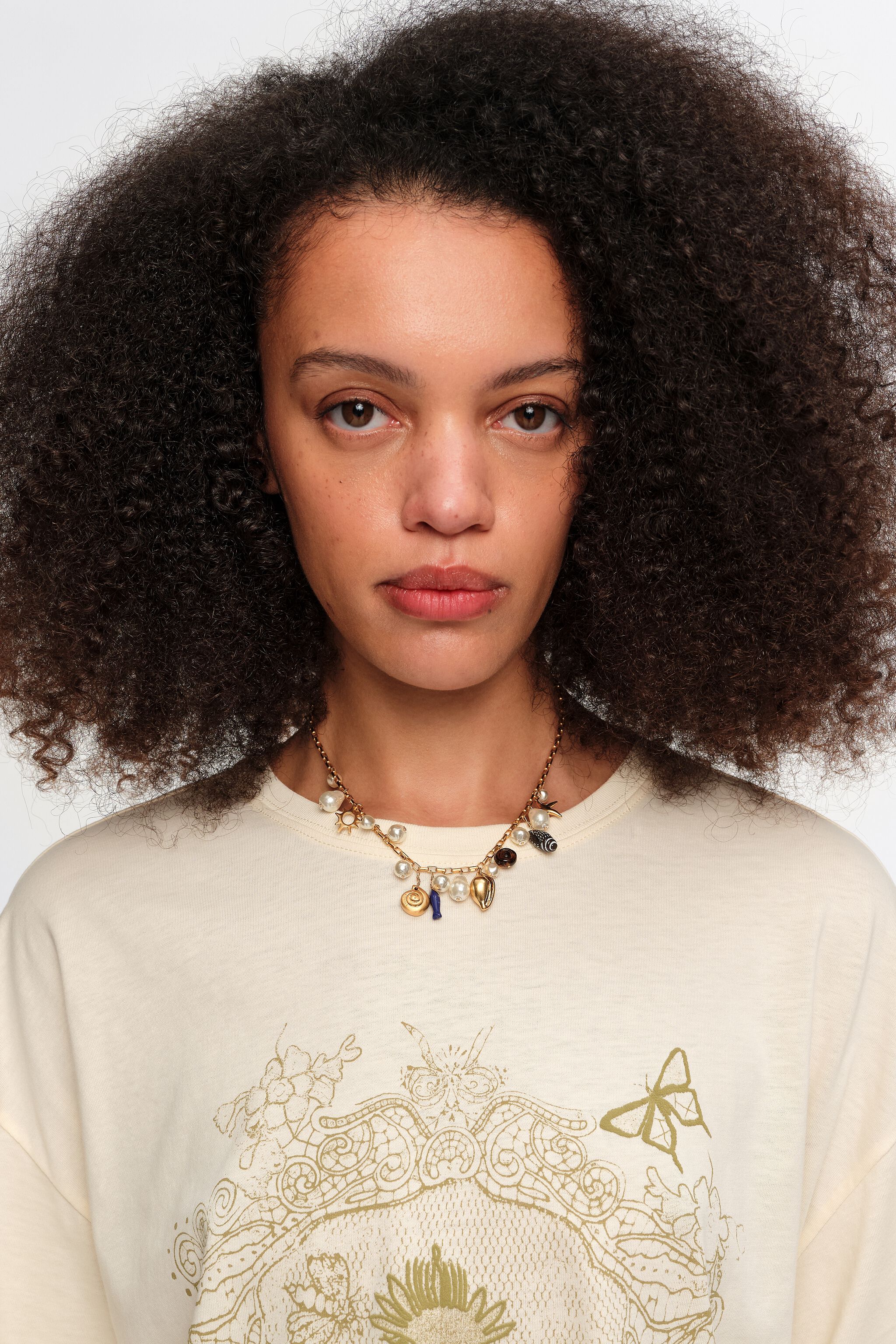 Aged gold necklace with shells and fish