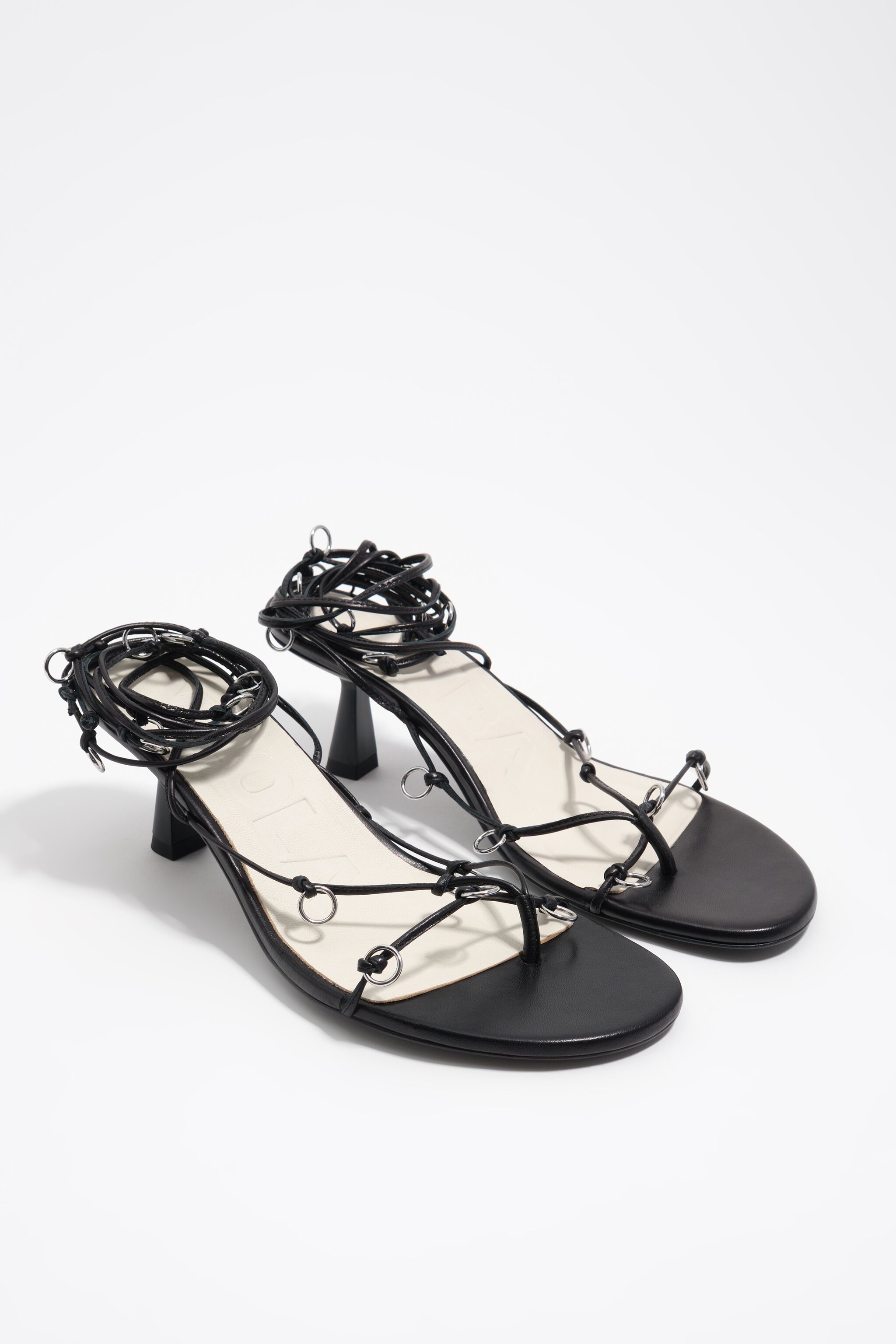 Black leather heeled sandal with piercings