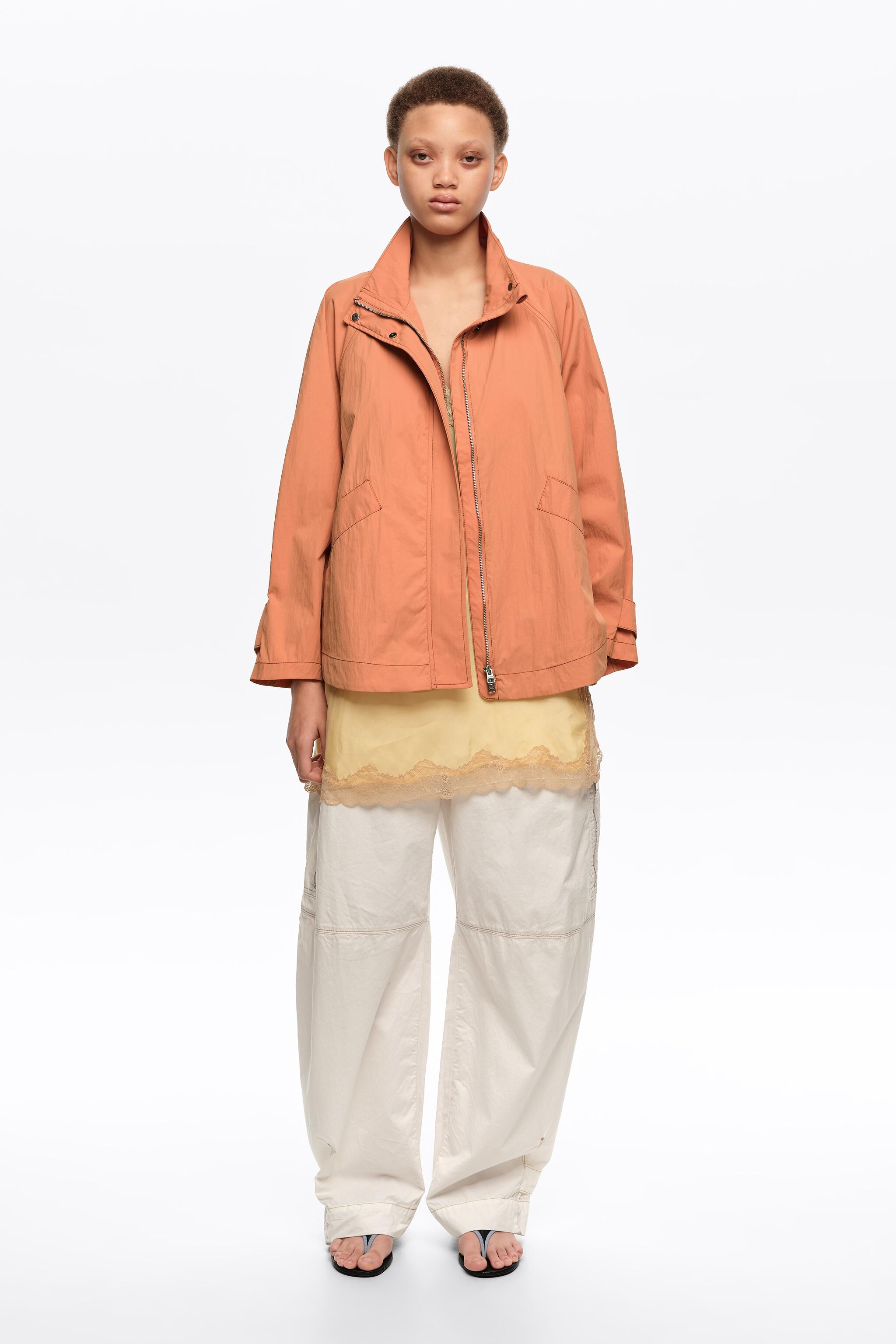 Short, orange fluid high neck trench