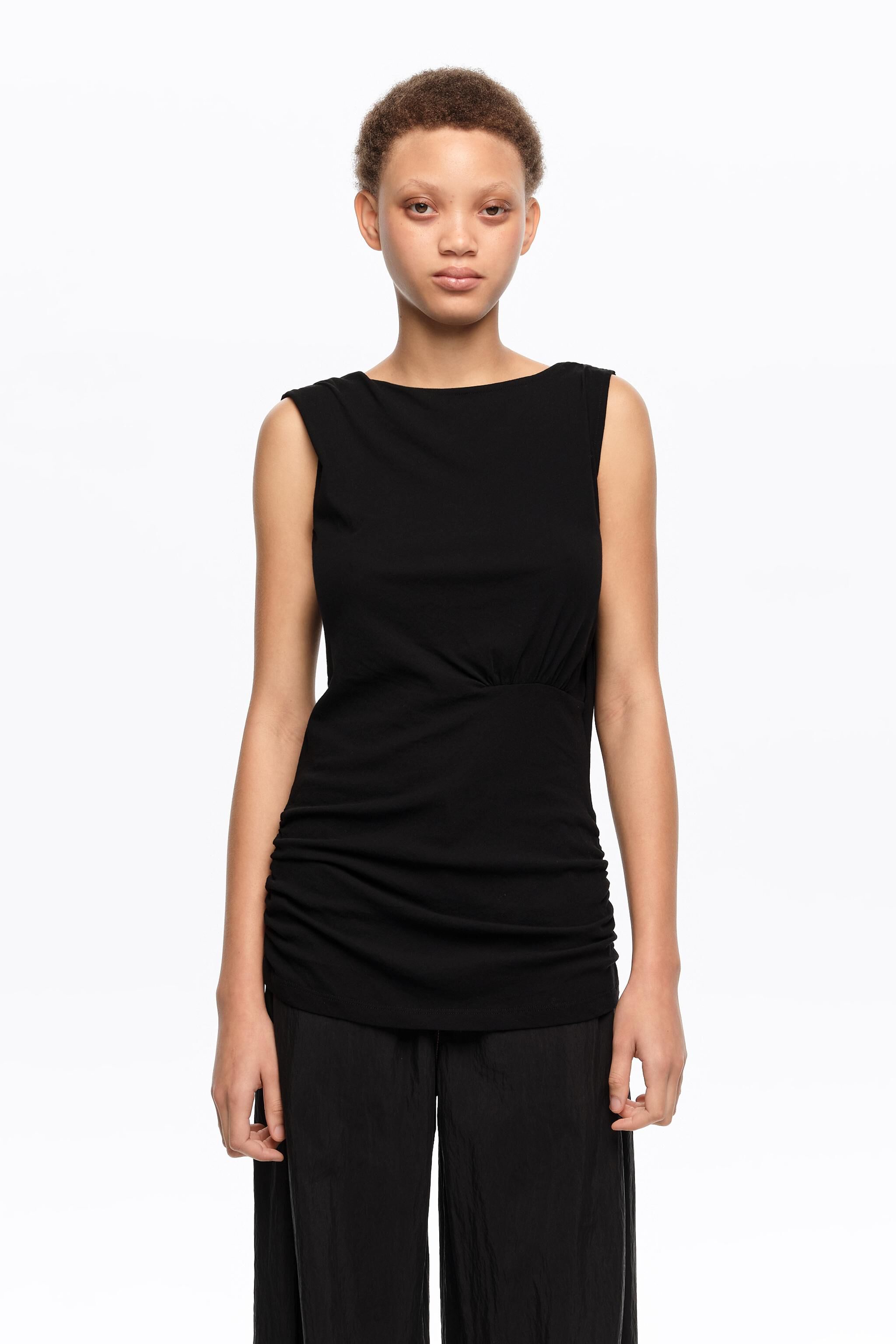 Black fitted elasticated top with dropped back