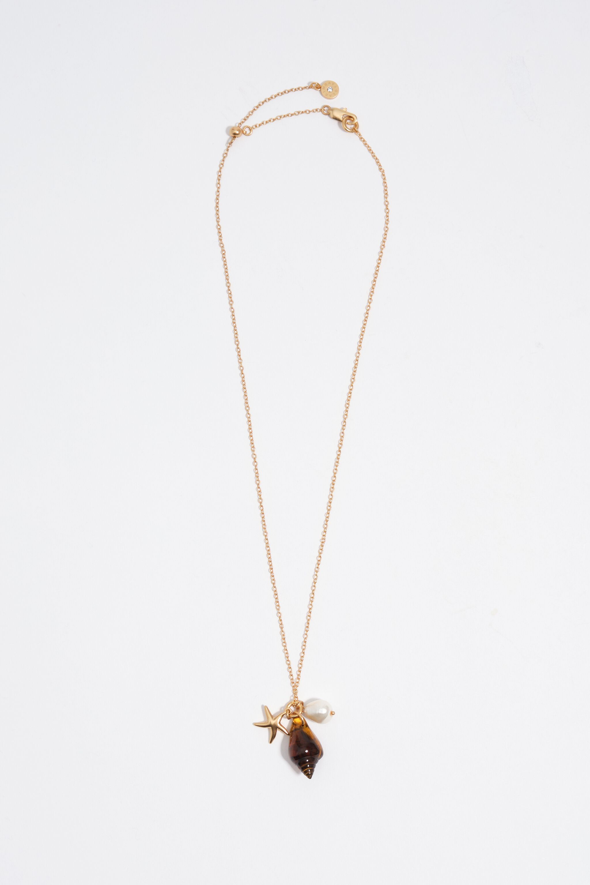 Aged gold star and shell necklace