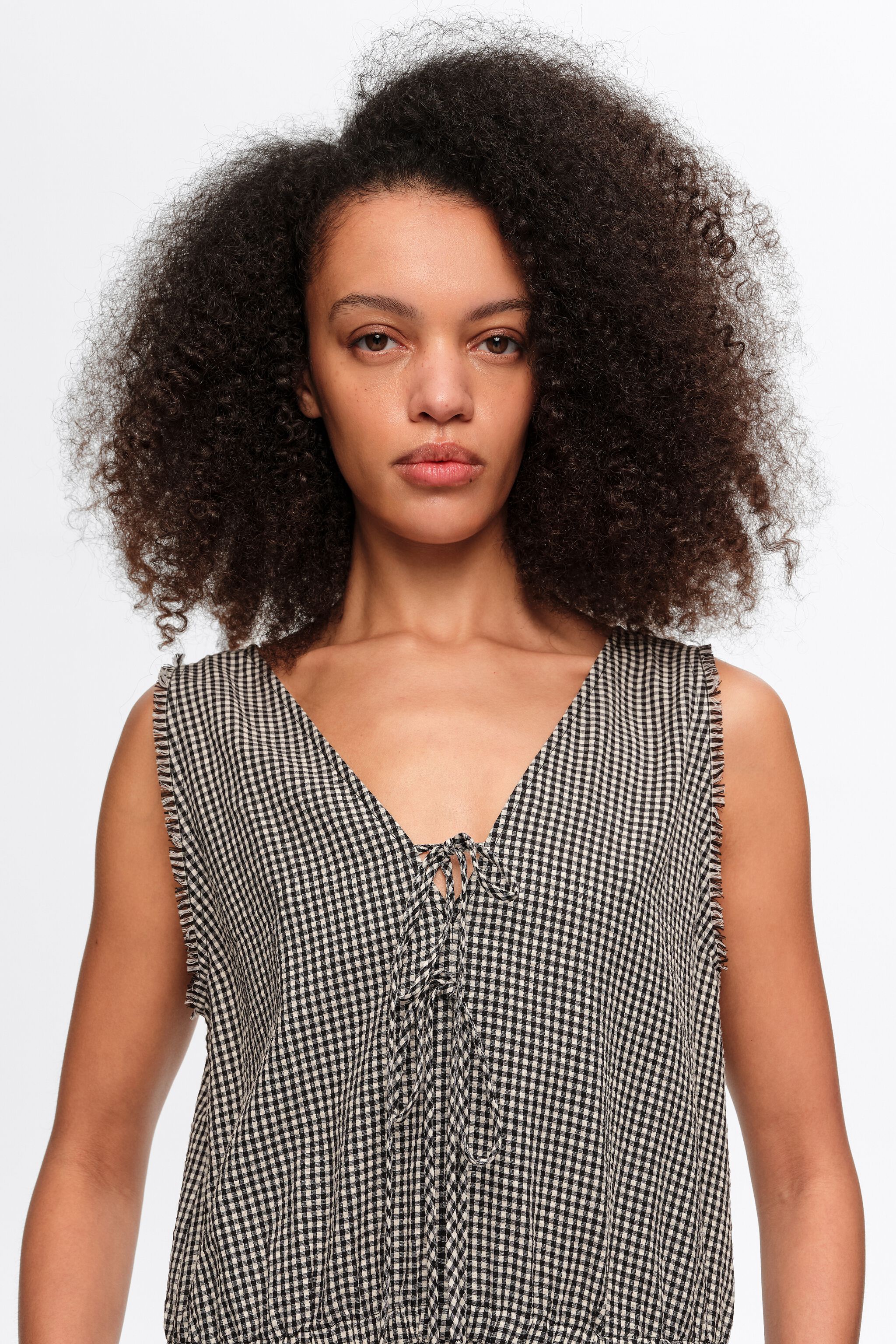 Black checked baggy jumpsuit with bows and frayed details