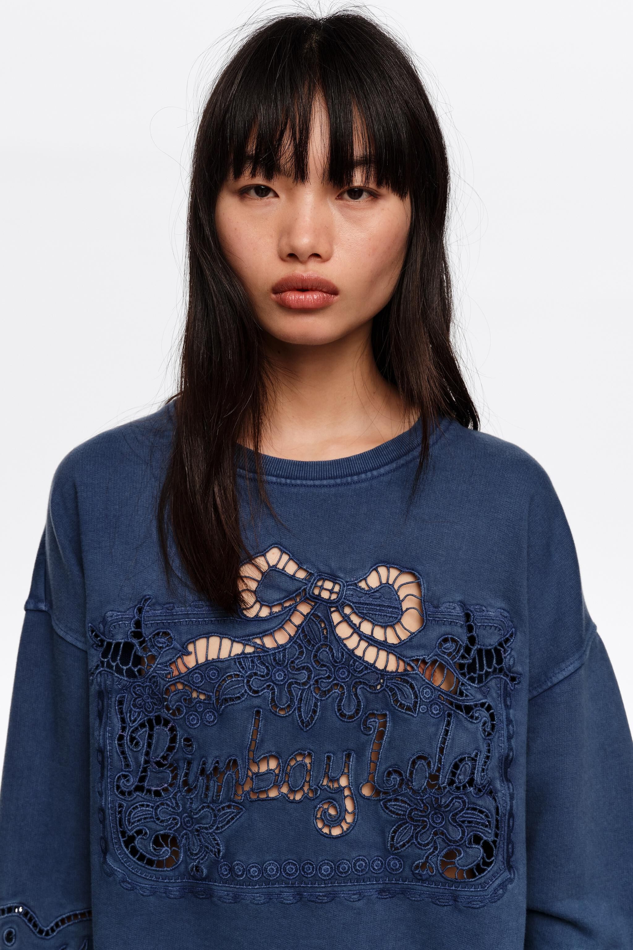 Faded blue sweatshirt with maxi broderie anglaise logo