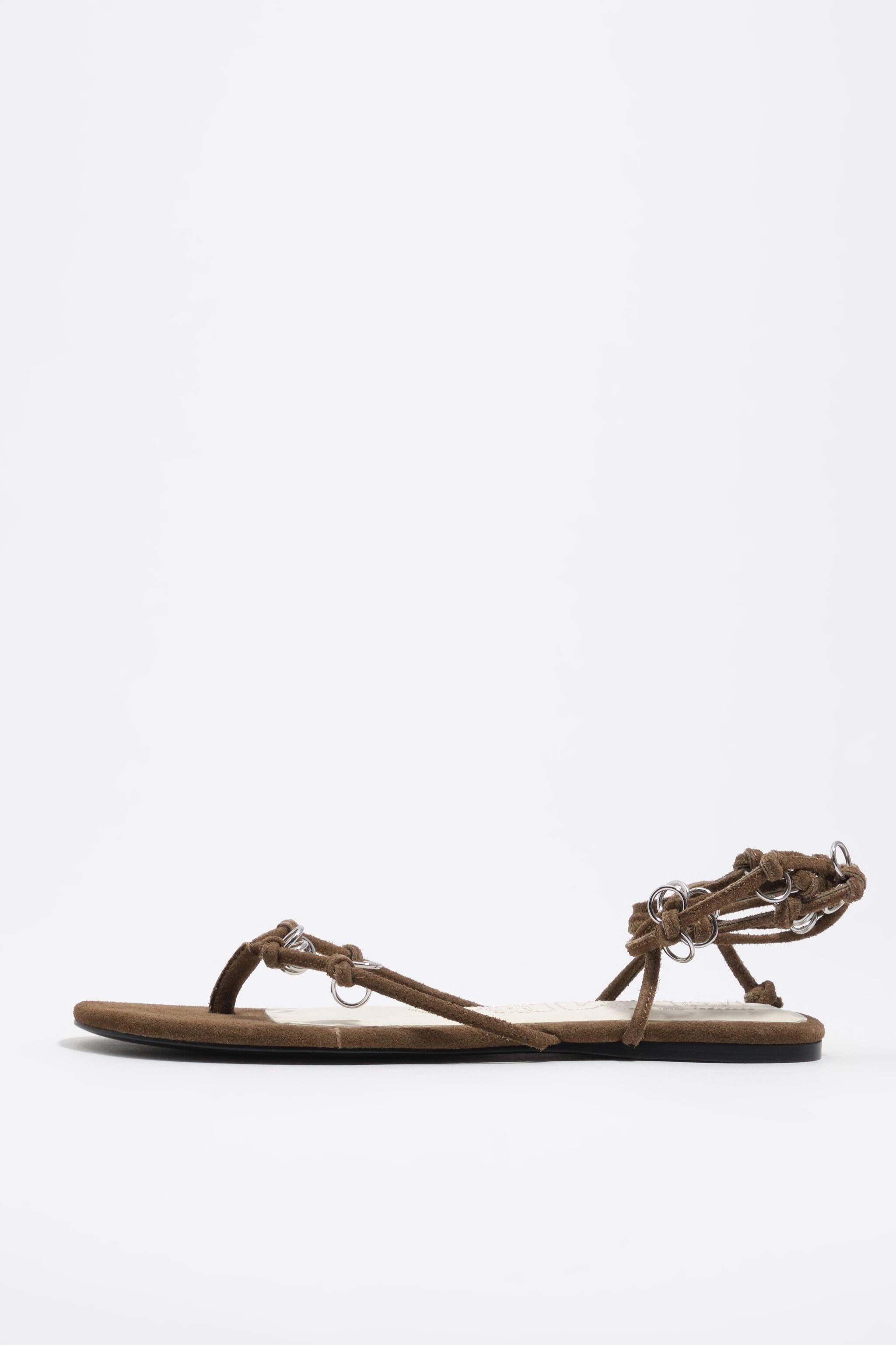Olive suede sandal with piercings
