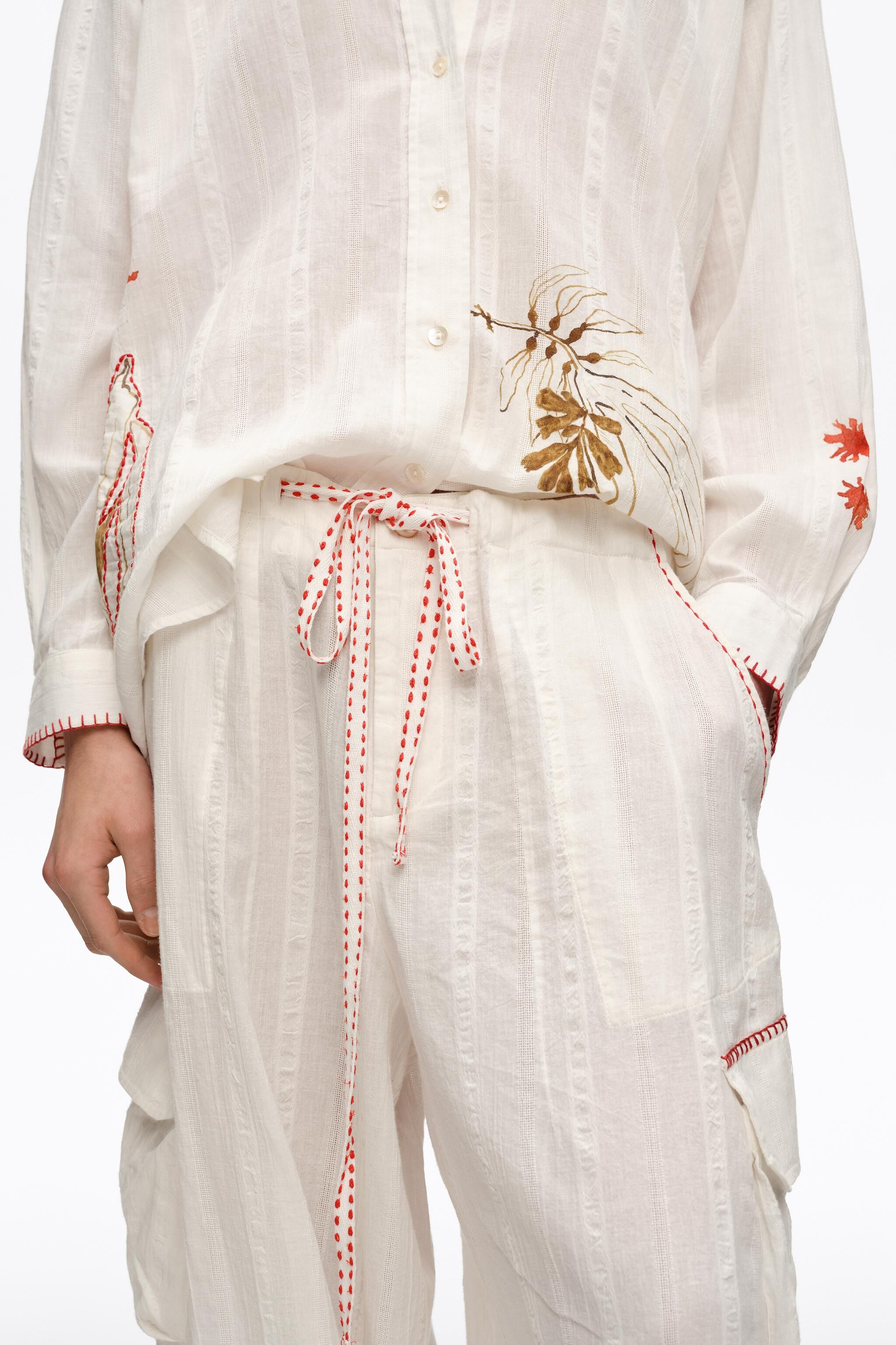 Ivory cargo pants with decorative stitching