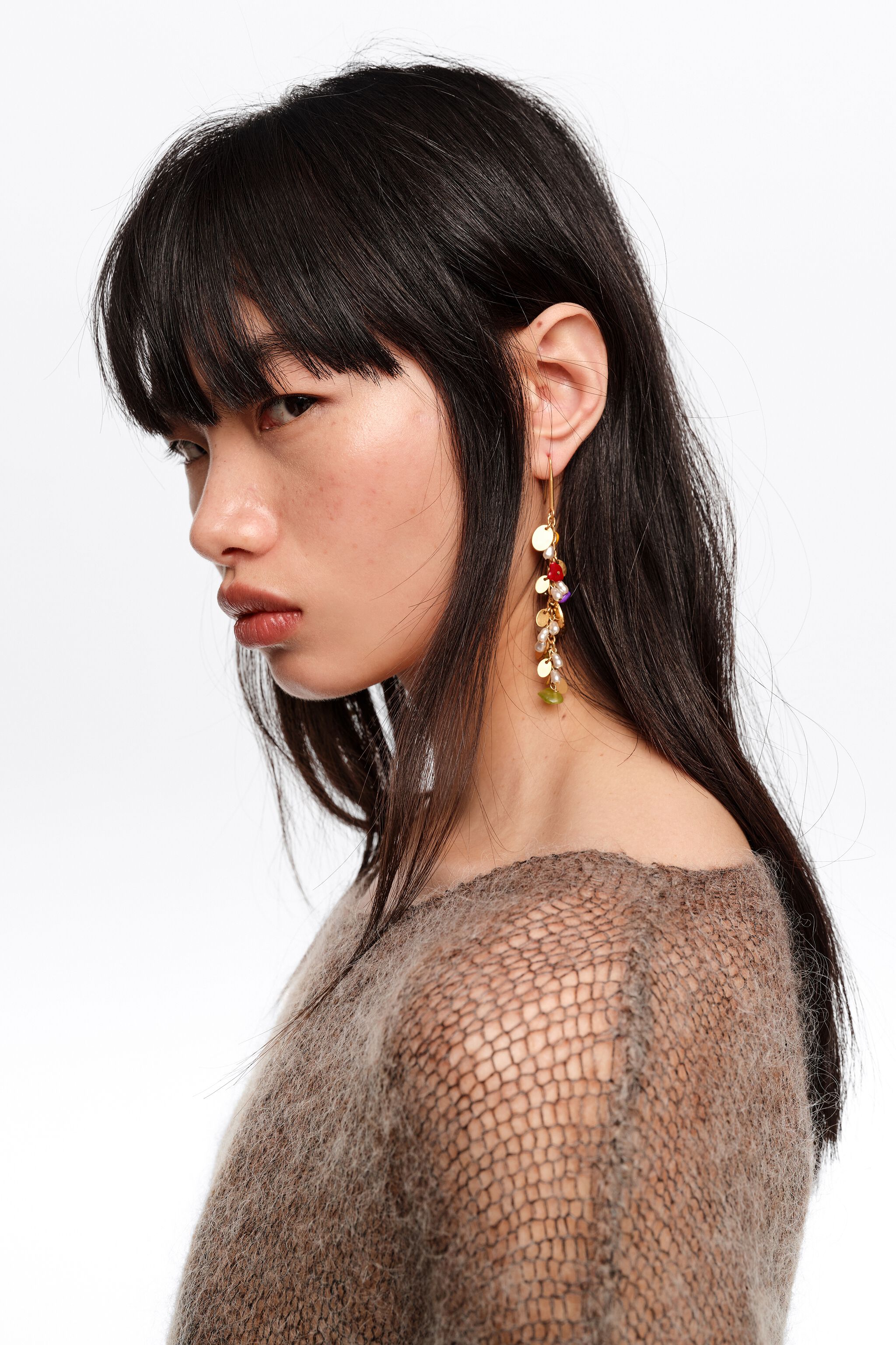 Earrings with stones and aged gold metal texture