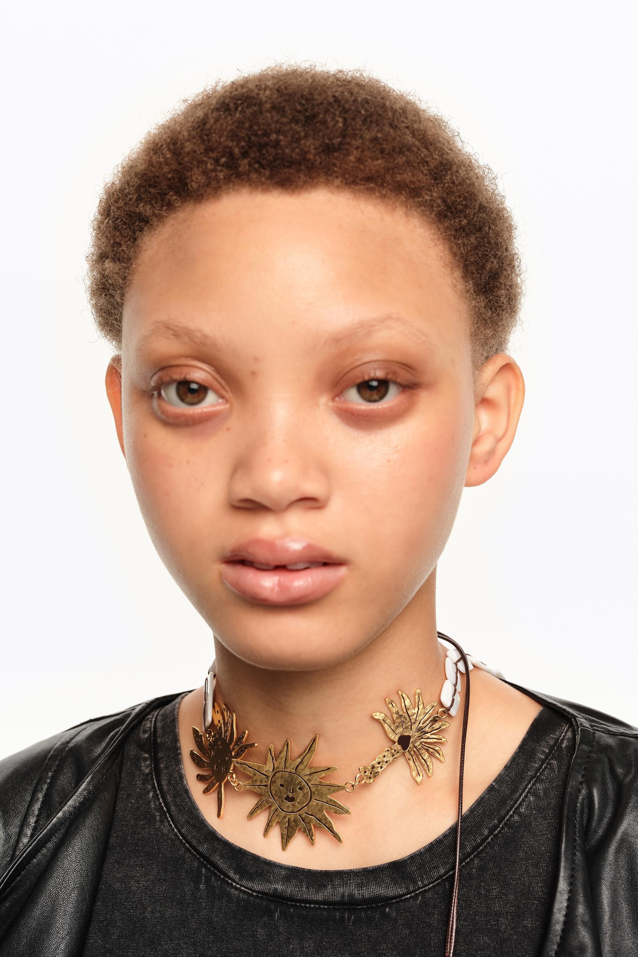 Brushed gold sun and animal necklace
