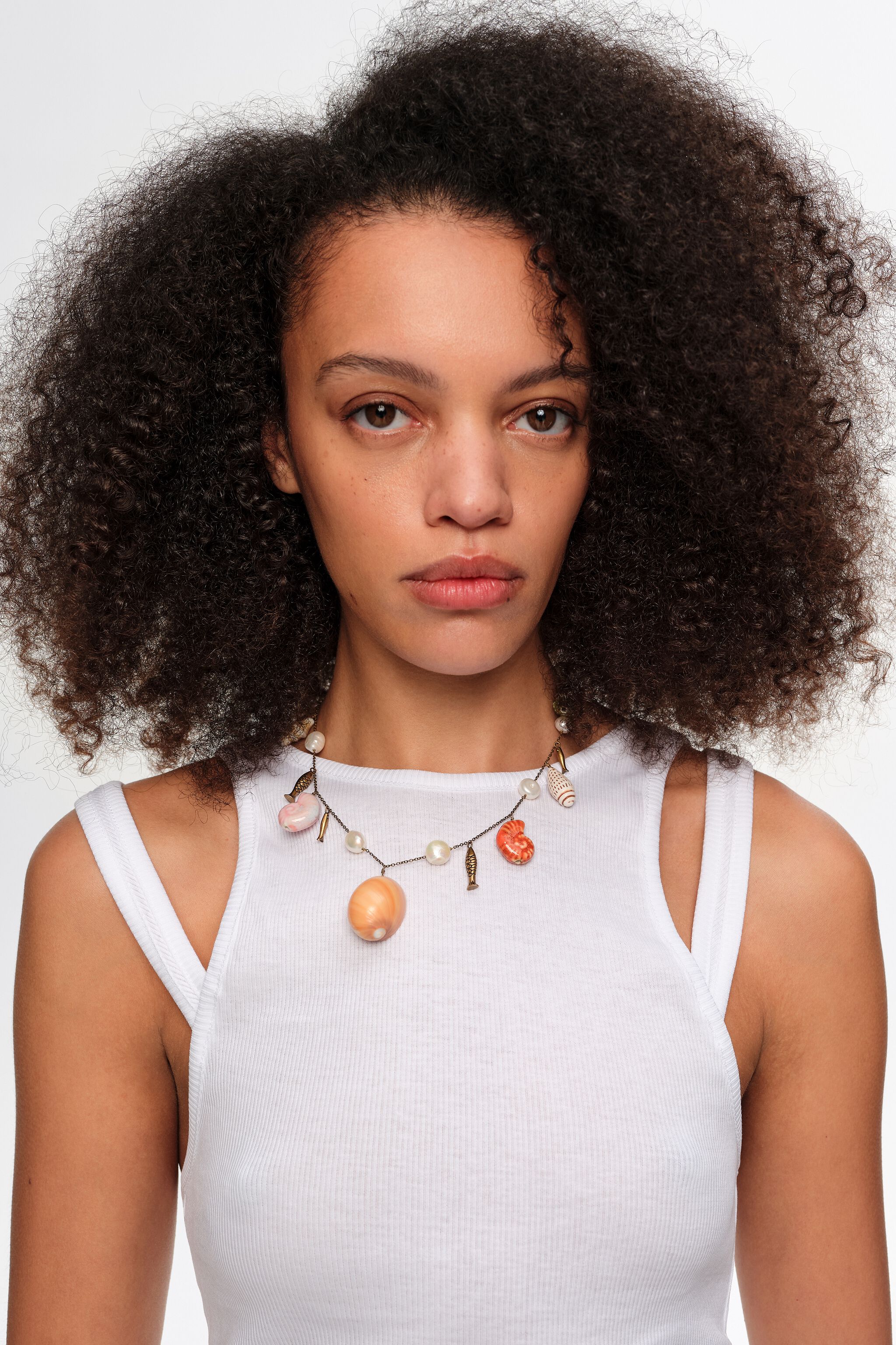Aged gold necklace with fish and shells