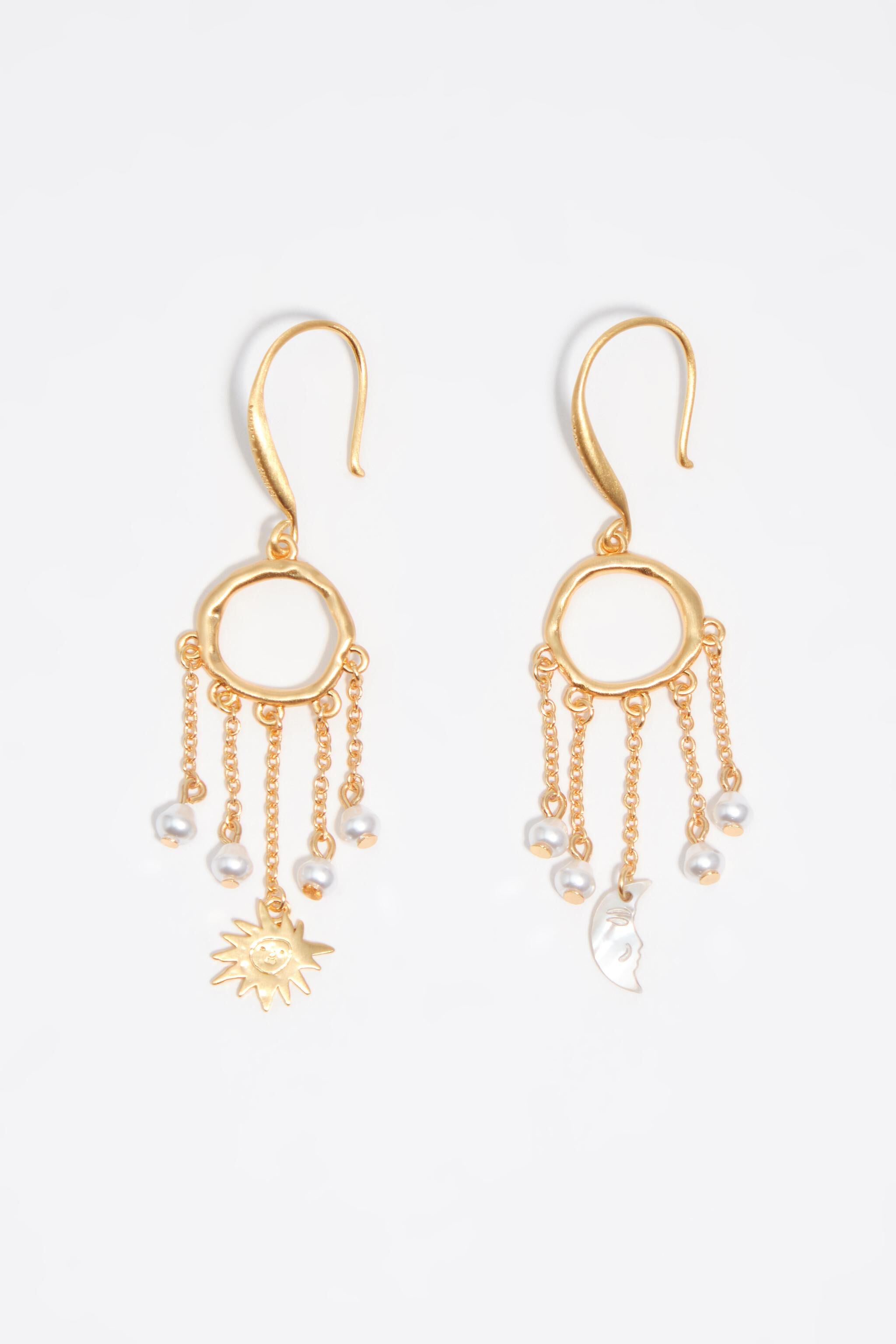 Sun and moon earrings with brushed gold chains and pearls