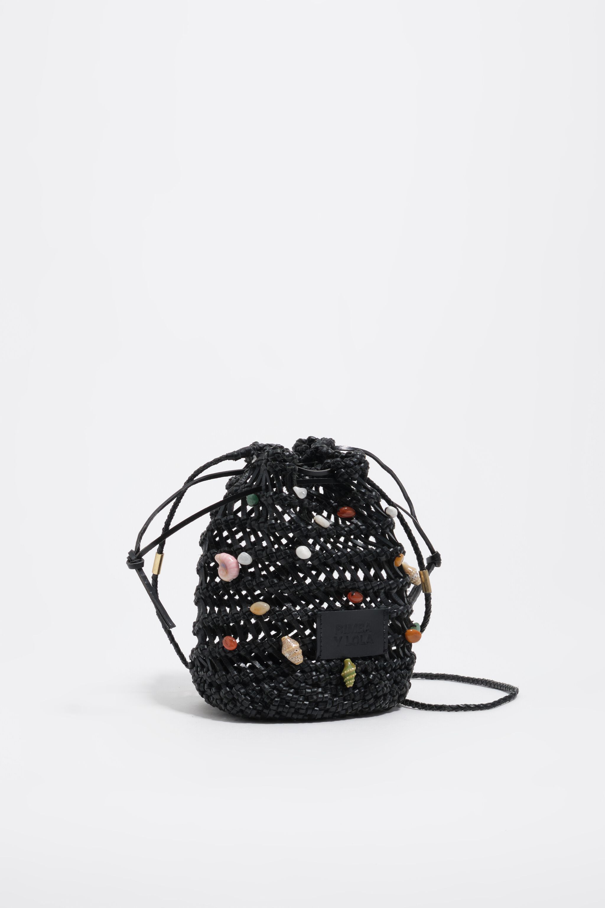 Black mini bucket bag in plaited leather with natural stones